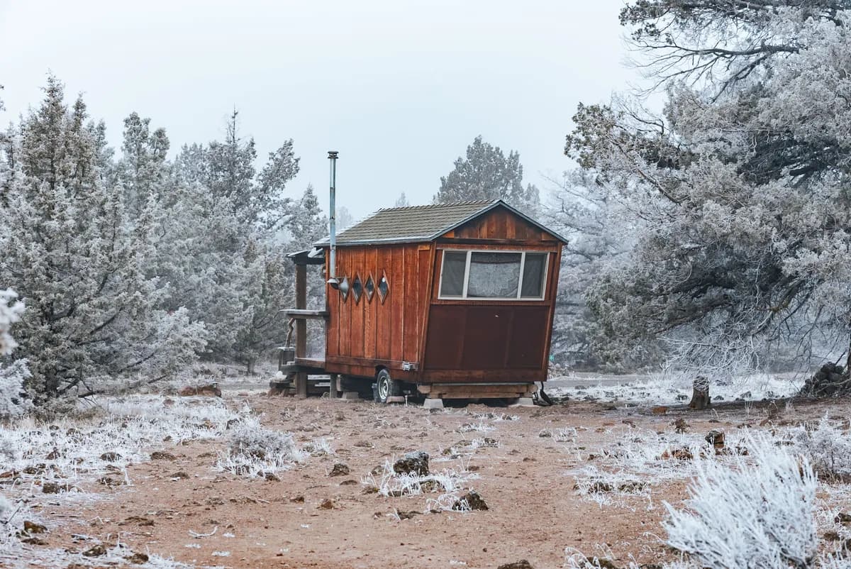 Immagine di esempio BookNoFees: piccola casetta di legno su ruote in un paesaggio innevato
